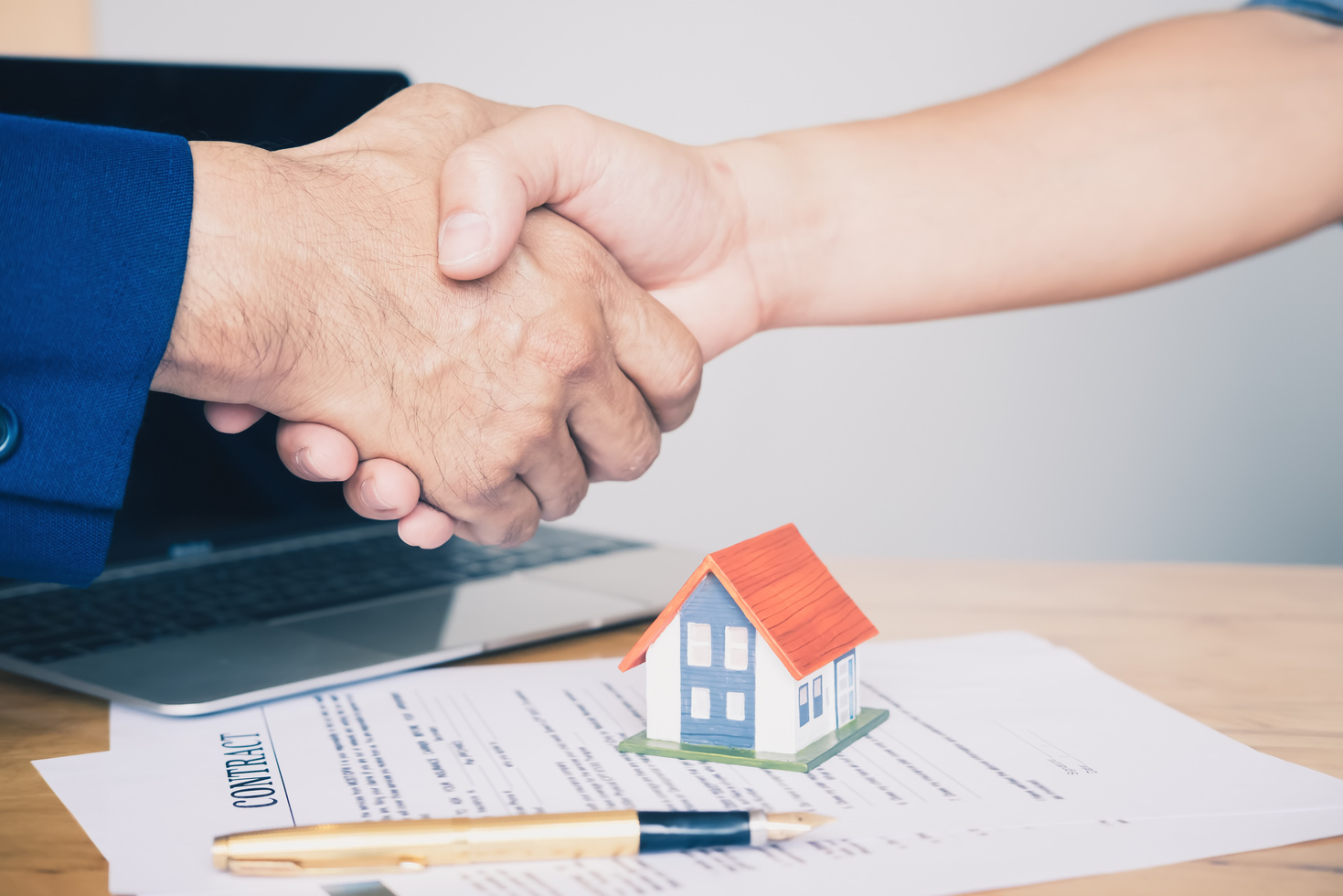 Real Estate Agent Shaking Hands to His Client after Signing Cont